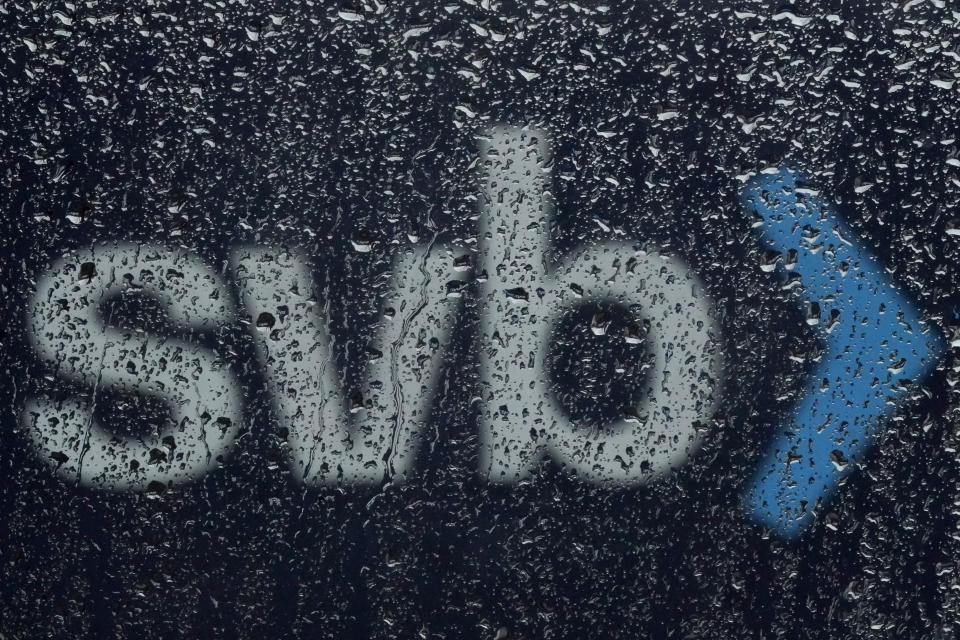 A sign to Silicon Valley Bank is seen through raindrops on a window in Santa Clara, Calif., Friday, March 10, 2023. The Federal Deposit Insurance Corporation is seizing the assets of Silicon Valley Bank, marking the largest bank failure since Washington Mutual during the height of the 2008 financial crisis. The FDIC ordered the closure of Silicon Valley Bank and immediately took position of all deposits at the bank Friday.(AP Photo/Jeff Chiu)