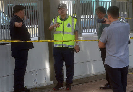 Police work in a cordoned off area after two unidentified men shot dead a Palestinian man in Kuala Lumpur, Malaysia April 21, 2018. REUTERS/Stringer