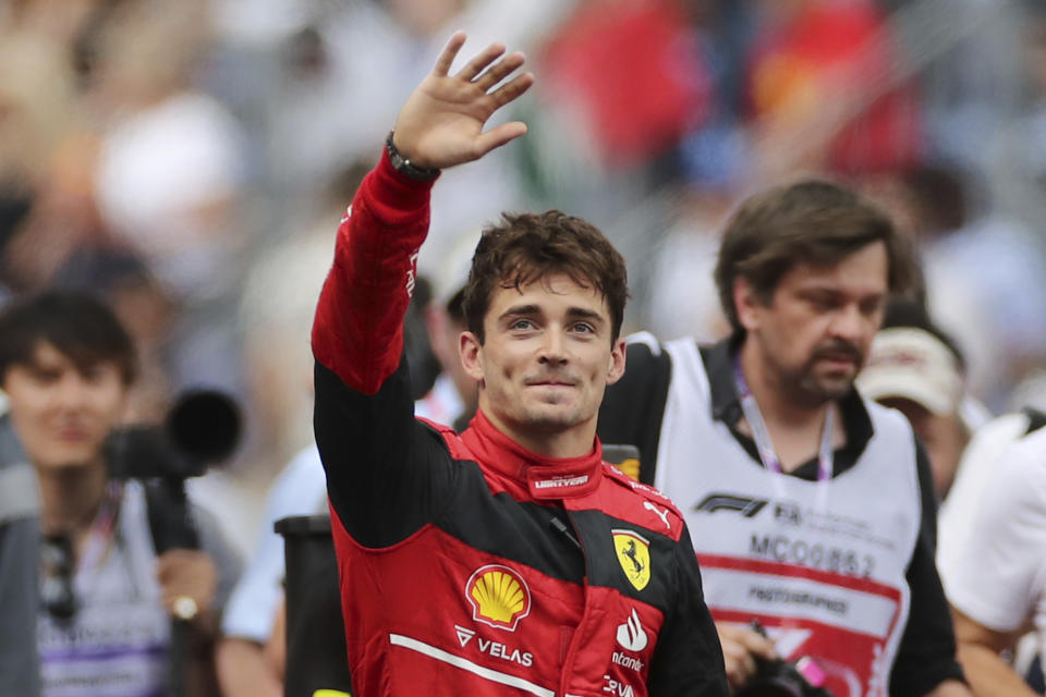 Ferrari driver Charles Leclerc of Monaco thumb up to spectators after setting the pole position in the qualifying session at the Monaco racetrack, in Monaco, Saturday, May 28, 2022. The Formula one race will be held on Sunday. (AP Photo/Daniel Cole)