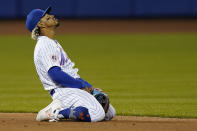 New York Mets shortstop Francisco Lindor reacts after a failed double-play attempt on a ball hit by Arizona Diamondbacks' Zac Gallen during the third inning of a baseball game, Friday, May 7, 2021, in New York. A runner was forced at second, and a run scored. (AP Photo/John Minchillo)