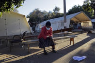 A woman sits on a bench while pondering her next move after COVID-19 vaccines ran out at a government hospital in Harare, Zimbabwe, on Saturday, July, 10, 2021. Official figures show that 4% of the country’s 15 million population are fully immunized. The figures make Zimbabwe a relative success in Africa, where fewer than 2% of the continent’s 1. 3 billion people have been vaccinated, according to the World Health Organization. (AP Photo/Tsvangirayi Mukwazhi)