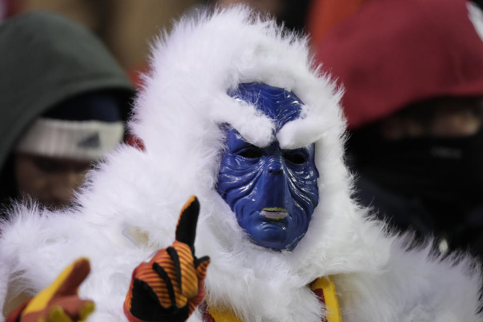 A fan in costume gestures before an NFL wild-card playoff football game between the Kansas City Chiefs and the Miami Dolphins on Saturday, Jan. 13, 2024, in Kansas City, Mo. (AP Photo/Charlie Riedel)
