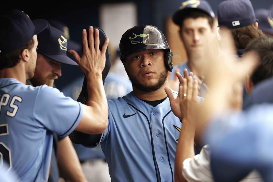 Tampa Bay Rays' Harold Ramirez reacts in the dugout after scoring against the Toronto Blue Jays during the sixth inning of a baseball game, Sunday, May 15, 2022, in St. Petersburg, Fla. (AP Photo/Scott Audette)