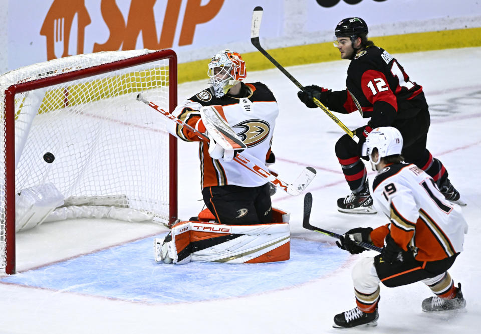 Ottawa Senators right wing Alex DeBrincat (12) watches his shot bounce in the net for a goal on Anaheim Ducks goaltender Lukas Dosta during the third period of an NHL hockey game in Ottawa, Ontario, Monday, Dec. 12, 2022. (Justin Tang/The Canadian Press via AP)