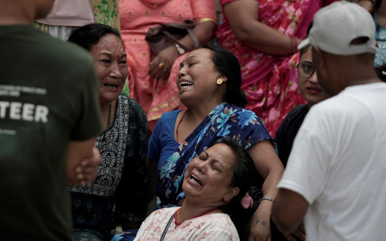 Family members of the victims attend a hosptial after hearing news of the plane crash