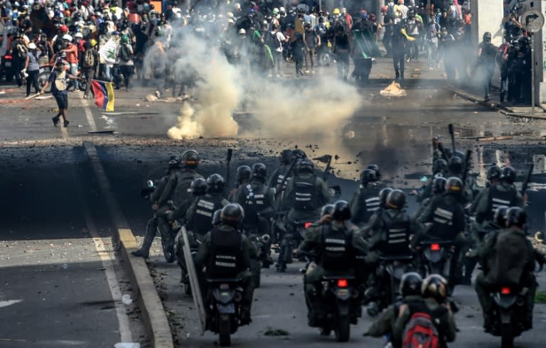 Riot police officers confront opposition activists during a demonstration against Venezuelan President Nicolas Maduro in Caracas, on May 26, 2017