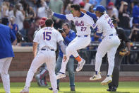 New York Mets Mark Vientos (27), center, celebrates with teammates after hitting a walk-off home run during the 11th inning of a baseball game against the St. Louis Cardinals at Citi Field, Sunday, April 28, 2024, in New York. (AP Photo/Seth Wenig)