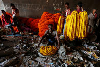 <p>Vendors sell garlands, which are used to decorate temples and homes during the Hindu festival of Durga Puja, at a wholesale flower market in Kolkata, India, Sept. 26, 2017. (Photo: Rupak De Chowdhuri/Reuters) </p>