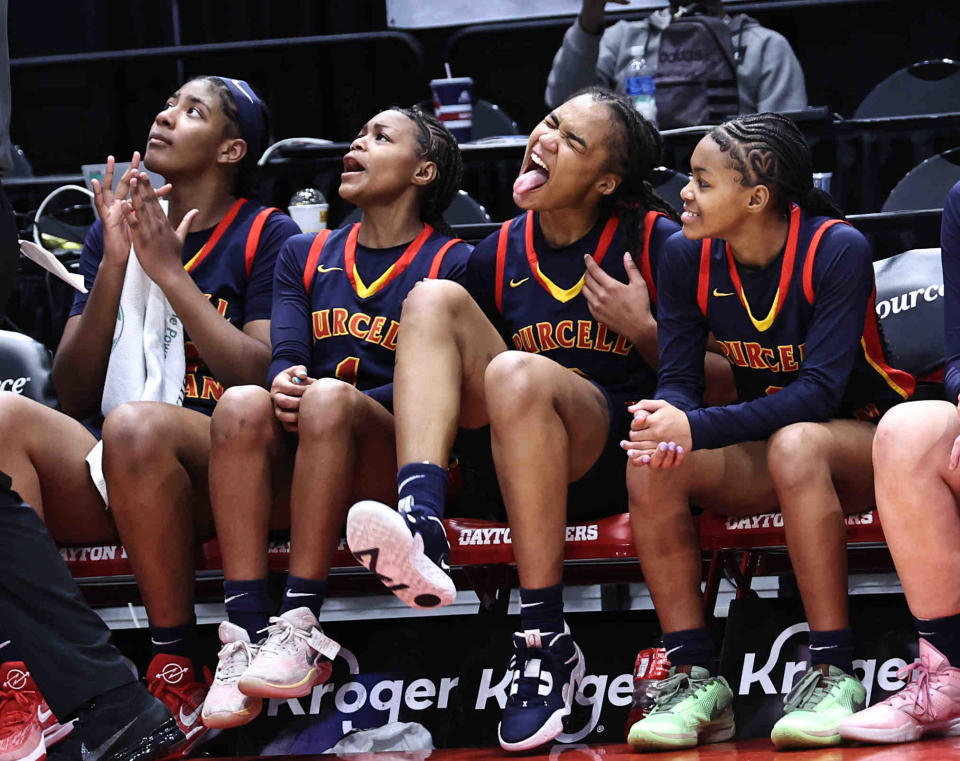 Purcell Marian player Samaya Wilkins (24), Dee Alexander, Cy'Aira Miller and Ky'Aria Miller celebrate as the clock winds down to their third championship in a row after beating Laurel in the OHSAA DII state final Saturday, March 16, 2024.