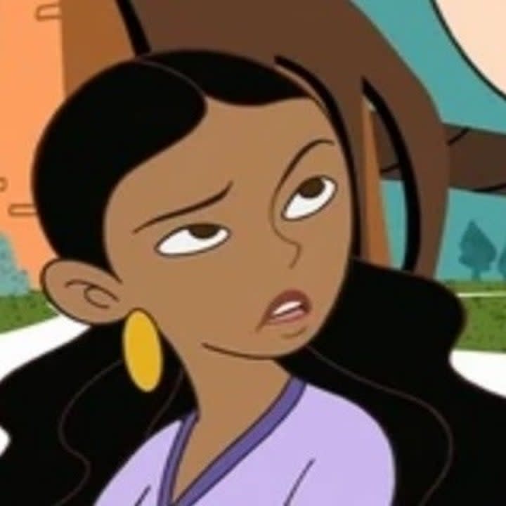 Monique from Disney's Kim Possible with one eyebrow raised and a slight frown