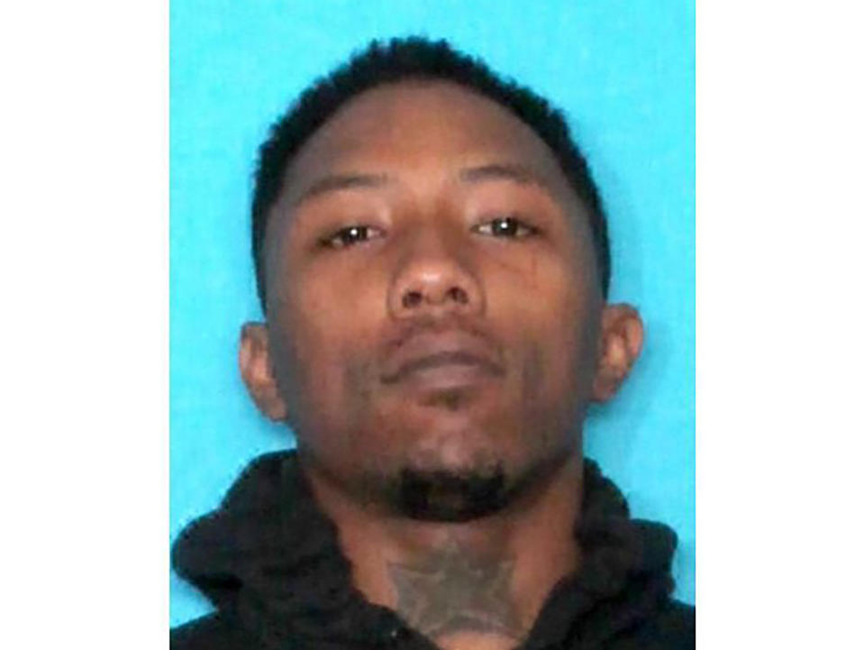 This undated photo provided by the New Orleans Police Department shows LaBryson Polidore. Still at large at this time of reporting was Polidore, 22, who faced 10 counts of attempted second-degree murder. Polidore was hit in the foot during the gunfight, Police Chief Shaun Ferguson said. (New Orleans Police Department via AP)