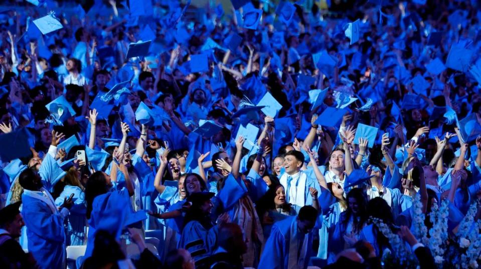 UNC graduates toss their mortar boards into the air at the conclusion of UNC Chapel Hill’s commencement ceremonies at Kenan Stadium in Chapel Hill, N.C., Saturday, May 11, 2024. Ethan Hyman/ehyman@newsobserver.com