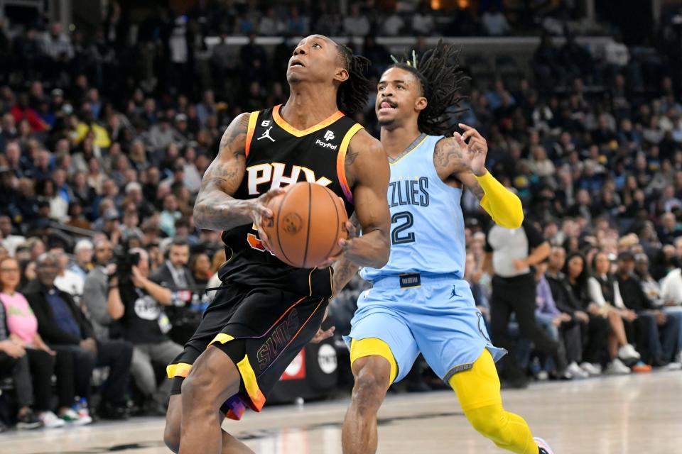 Phoenix Suns guard Saben Lee (left) drives ahead of Memphis Grizzlies guard Ja Morant in the first half of an NBA basketball game on Monday, Jan. 16, 2023, in Memphis, Tenn.