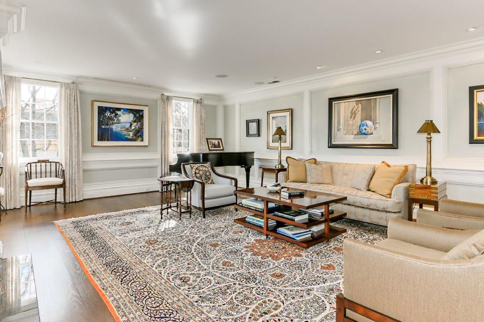 The formal living room includes hardwood floors and elegant moldings.