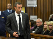 Oscar Pistorius is watched by June Steenkamp, 2nd right, the mother of Reeva Steenkamp, as he arrives for his trial at the high court in Pretoria, South Africa, Monday, March 3, 2014. Pistorius is charged with murder with premeditation in the shooting death of girlfriend Reeva Steenkamp in the pre-dawn hours of Valentine's Day 2013. (AP Photo/Herman Verwey, Media24- Pool)