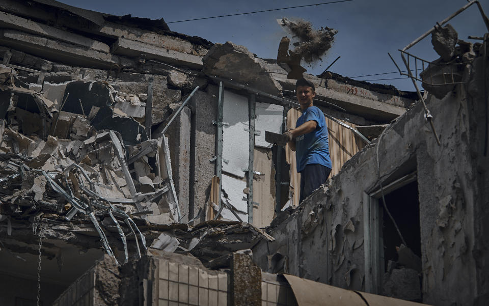 A man cleans an apartment destroyed after Russian shelling in Nikopol, Ukraine, Monday, Aug. 15, 2022. (AP Photo/Kostiantyn Liberov)