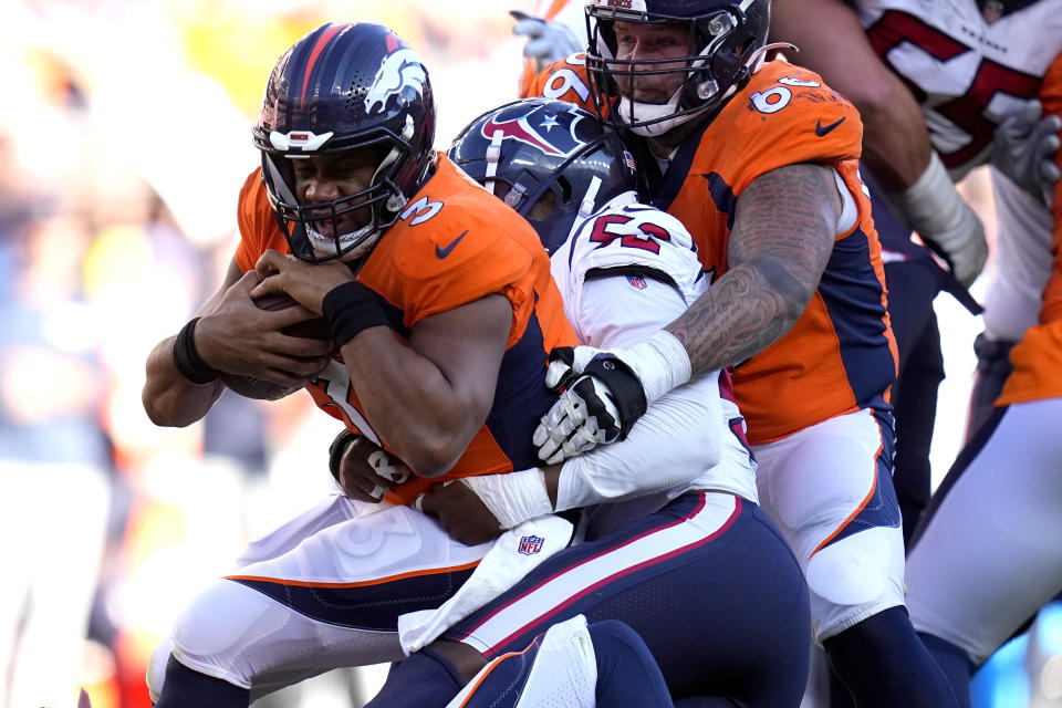 Denver Broncos quarterback Russell Wilson (3) his sacked by Houston Texans linebacker Blake Cashman (53) during the second half of an NFL football game, Sunday, Sept. 18, 2022, in Denver. (AP Photo/Jack Dempsey)