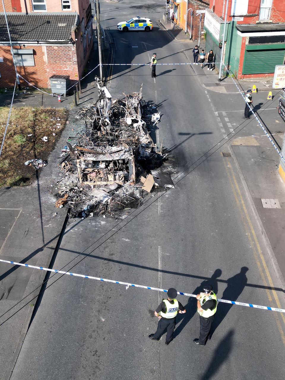 A police cordon was set up around  the charred remains of the bus (Getty Images)