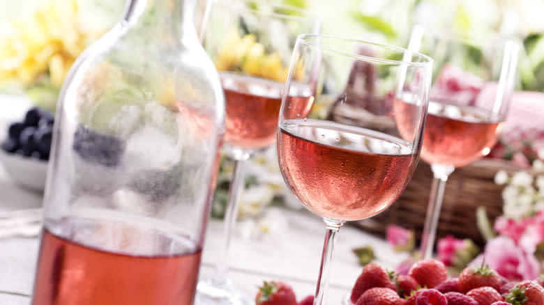 Glasses of rosé and berries on a table