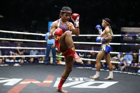 Muay Thai boxer Nong Rose Baan Charoensuk (L), 21, who is transgender, and Priewpak Sorjor Wichit-Padrew perform the Muay Thai traditional dance before their boxing match at the Rajadamnern Stadium in Bangkok, Thailand, July 13, 2017. REUTERS/Athit Perawongmetha