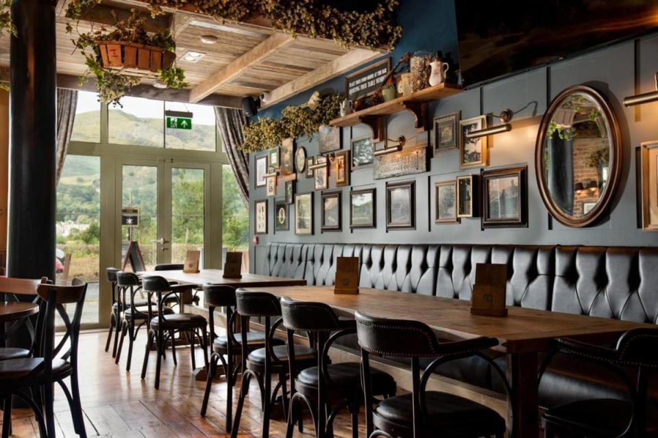 The pub has a cool country vibe, with leather sofas and antique artworks (Booking.com)