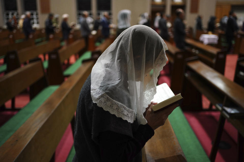 In this Nov. 17, 2019, photo, Catholics attend an early morning Mass at the Urakami Cathedral in Nagasaki, southern Japan. Pope Francis will start his first official visit to Japan in Nagasaki, ground zero for the Christian experience in a nation where the Catholic leader once dreamed of living as a missionary. (AP Photo/Eugene Hoshiko)