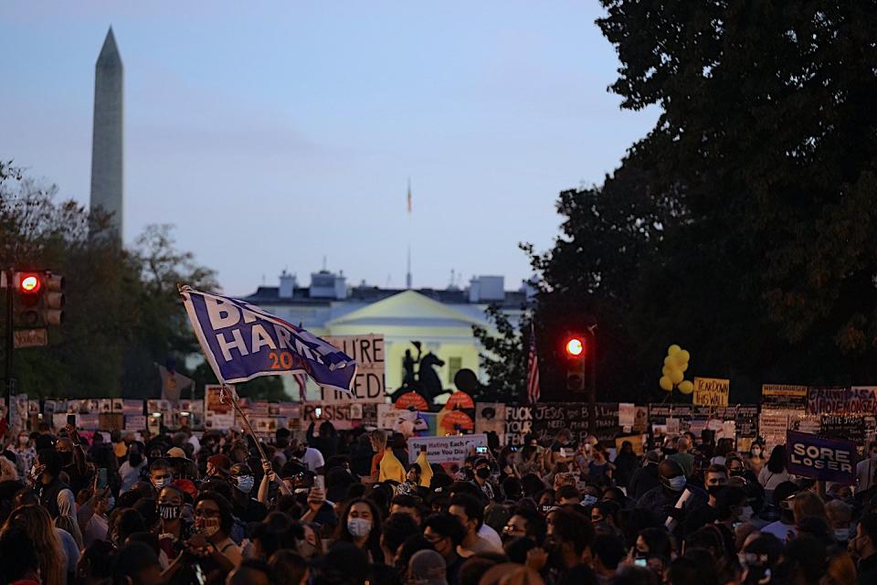 Supporters of US president elect Joe Biden celebrate at a rally at black lives matter plaza near the White House after Biden was declared winner of the US presidency (AFP via Getty)