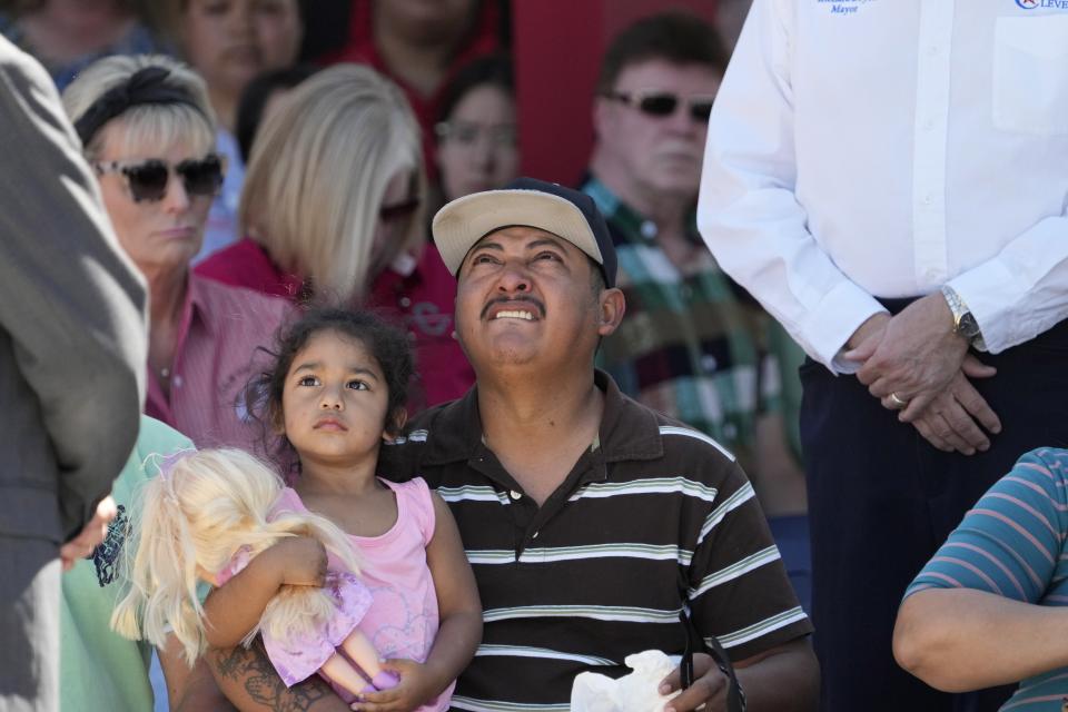 Mass shooting survivor Wilson Garcia looks up to the sky during a vigil for his son Daniel Enrique Laso, 9, Sunday, April 30, 2023, in Cleveland, Texas. Garcia's son and wife were killed in the shooting Friday night. The search for a Texas man who allegedly shot his neighbors after they asked him to stop firing off rounds in his yard stretched into a second day Sunday, with authorities saying the man could be anywhere by now. The suspect fled after the shooting Friday night that left five people dead. (AP Photo/David J. Phillip)