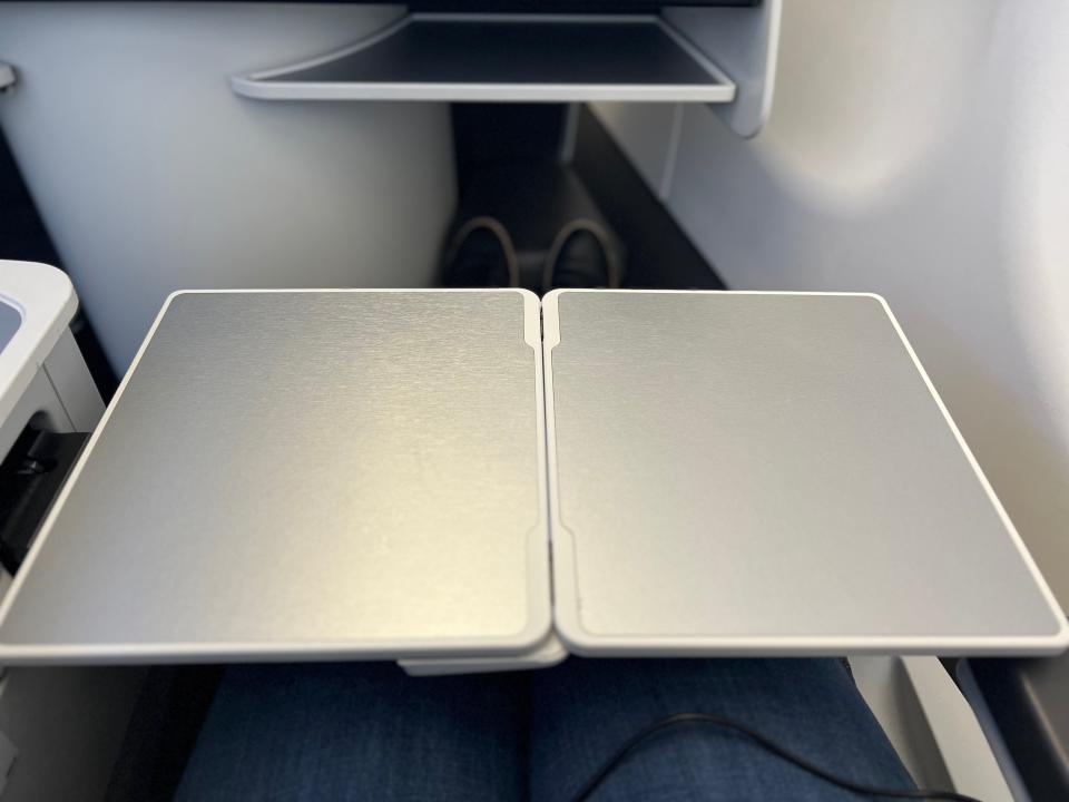 Flying on La Compagnie all-business class airline from Paris to New York — the tray table folded out.