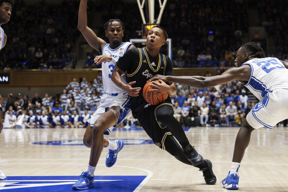 La Salle's Jhamir Brickus, middle, drives as Duke's Jeremy Roach (3) and Mark Mitchell (25) defend during the first half of an NCAA college basketball game in Durham, N.C., Tuesday, Nov. 21, 2023. (AP Photo/Ben McKeown)