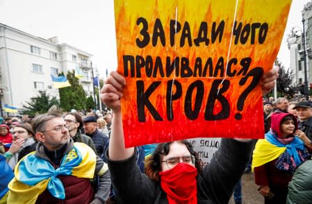 People attend a rally against approval of so-called Steinmeier Formula, in Kiev