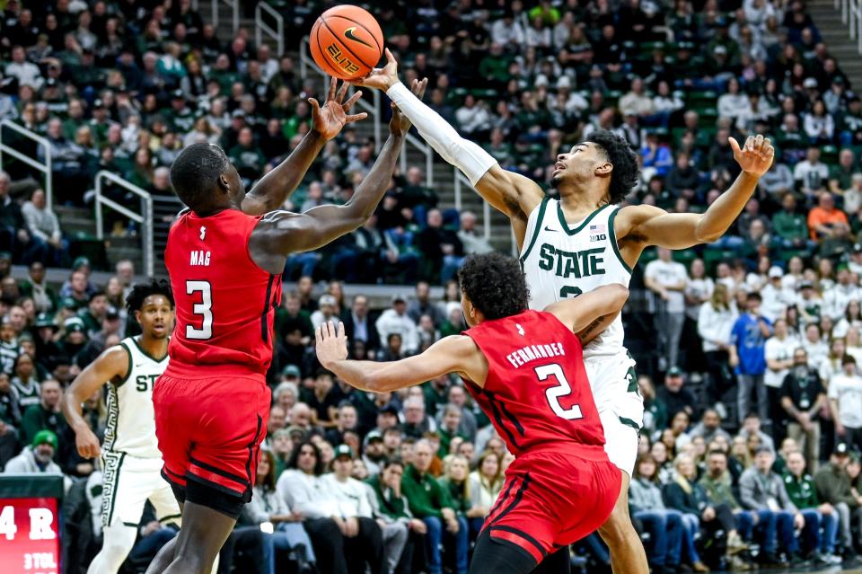 Michigan State's Jaden Akins, right, and Rutgers' Mawot Mag go after a rebound during the first half on Sunday, Jan. 14, 2024, at the Breslin Center in East Lansing.