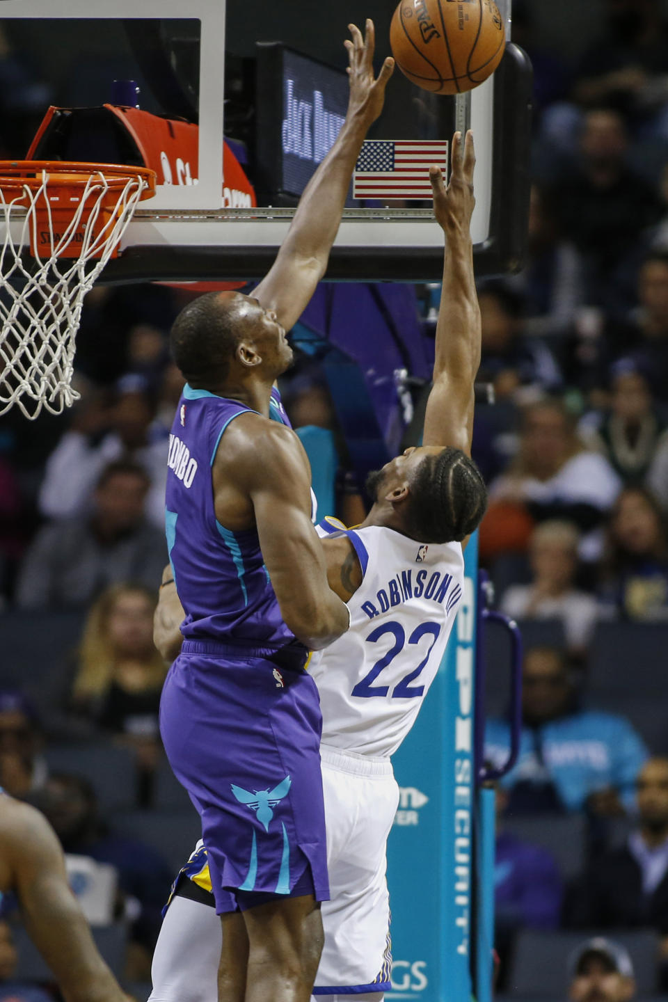 Golden State Warriors forward Glenn Robinson III (22) shoots as Charlotte Hornets center Bismack Biyombo defends during the first half of an NBA basketball game in Charlotte, N.C., Wednesday, Dec. 4, 2019. (AP Photo/Nell Redmond)