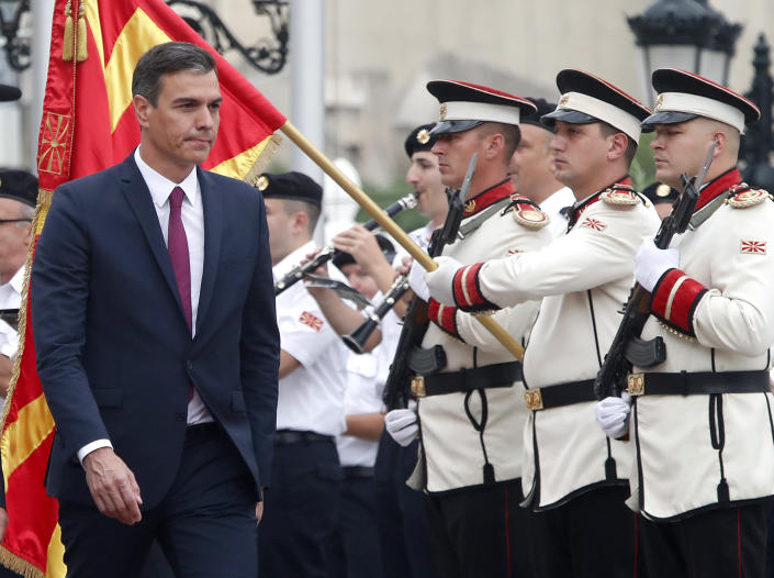 Spanish Prime Minister Pedro Sanchez walks past an honor guard squad, accompanied by North Macedonia's Prime Minister Dimitar Kovacevski, during a welcome ceremony at the government building in Skopje, North Macedonia, on Sunday, July 31, 2022. Spanish Prime Minister Pedro Sanchez is on a one-day official visit to North Macedonia as a part of his Western Balkans tour. (AP Photo/Boris Grdanoski)