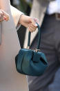 <p>A close-up of Meghan Markle’s Gabriela Hearst Demi emerald satin handbag, ($1,995, <a rel="noopener" href="https://go.skimresources.com?id=125078X1586062&xs=1&url=https%3A%2F%2Fwww.net-a-porter.com%2Fus%2Fen%2Fproduct%2F1108792" target="_blank" data-ylk="slk:net-a-porter.com;elm:context_link;itc:0;sec:content-canvas" class="link ">net-a-porter.com</a>) during an official visit to Sussex. (Photo: Getty) </p>