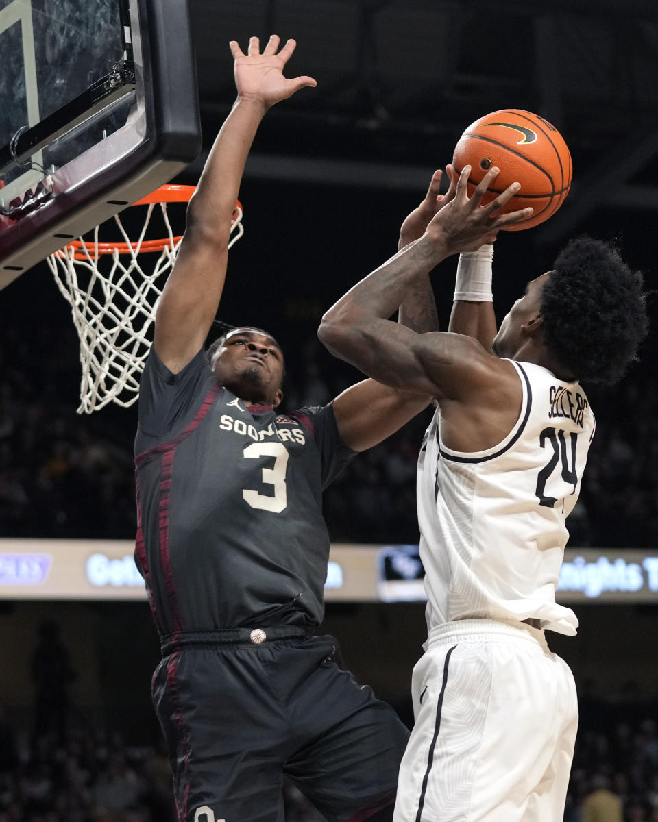 Central Florida guard Jaylin Sellers (24) makes a shot over Oklahoma guard Otega Oweh (3) during the second half of an NCAA college basketball game, Saturday, Feb. 3, 2024, in Orlando, Fla. (AP Photo/John Raoux)