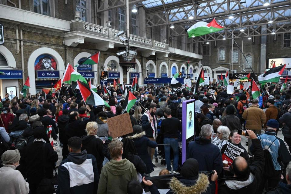 Protesters take part in a protest inside Charing Cross station (AFP via Getty Images)