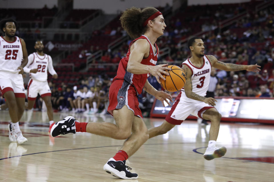 New Mexico's Josiah Allick drives past Fresno State's Isaiah Hill during the second half of an NCAA college basketball game in Fresno, Calif., Tuesday, Jan. 3, 2023. (AP Photo/Gary Kazanjian)