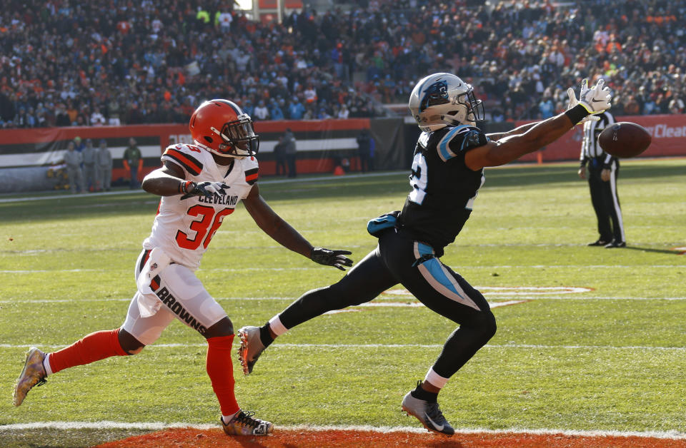 Carolina Panthers wide receiver D.J. Moore, right, reaches but can't catch the pass under pressure from Cleveland Browns defensive back T.J. Carrie during the first half of an NFL football game, Sunday, Dec. 9, 2018, in Cleveland. (AP Photo/Ron Schwane)