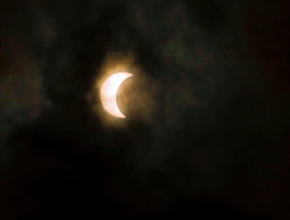 This is a view of Monday's solar eclipse through partly cloudy skies above Creekside Middle School in Port Orange.