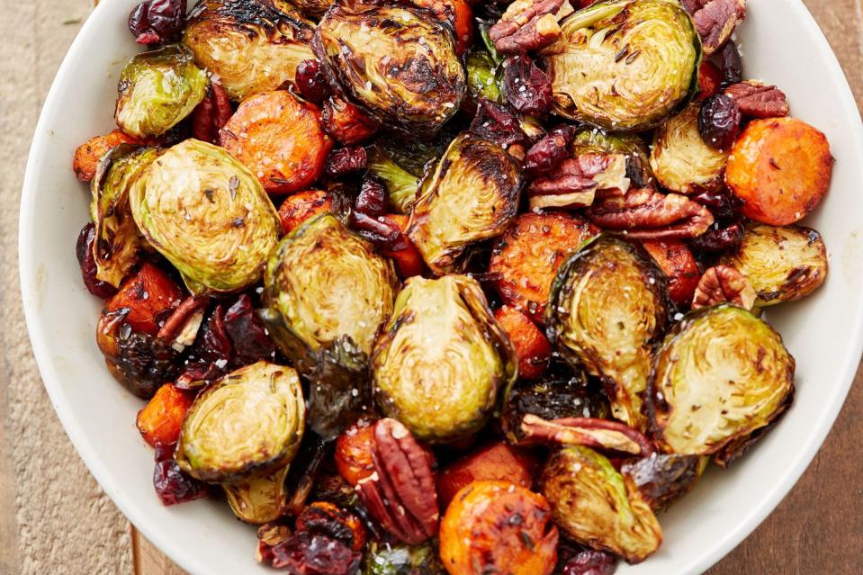 <p>This colorful medley <em>is</em> great for fall and winter holidays, but we think it's worthy of a spot on your plate all season long. The dried cranberries and balsamic vinegar add some sweetness and tartness while the pecans add an extra crunch. We use Brussels sprouts and carrots, but feel free to add extra vegetables or swap in some of your favorites. </p><p>Get the <strong><a href="https://www.delish.com/cooking/recipe-ideas/recipes/a50228/holiday-roasted-vegetables-recipe/" rel="nofollow noopener" target="_blank" data-ylk="slk:Roasted Vegetable Medley recipe;elm:context_link;itc:0;sec:content-canvas" class="link ">Roasted Vegetable Medley recipe</a></strong>.</p>