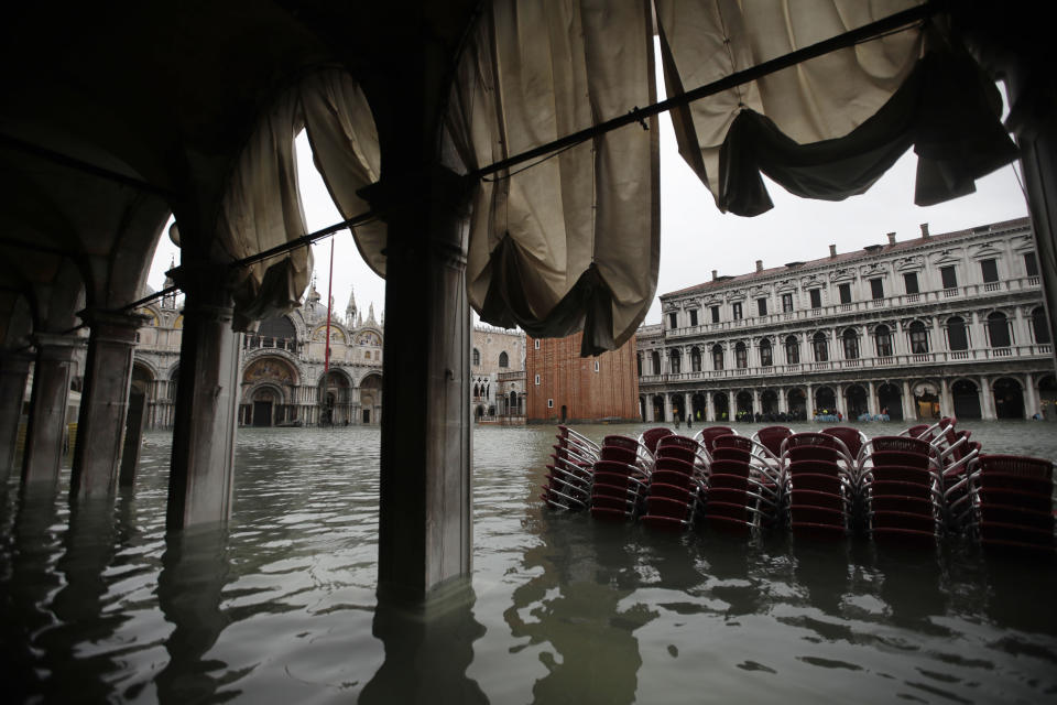 Chairs are piled up in the water in a flooded St. Mark's Square in Venice, Italy, Friday, Nov.15, 2019. The high-water mark hit 187 centimeters (74 inches) late Tuesday, Nov. 12, 2019, meaning more than 85% of the city was flooded. The highest level ever recorded was 194 centimeters (76 inches) during infamous flooding in 1966. (AP Photo/Luca Bruno)