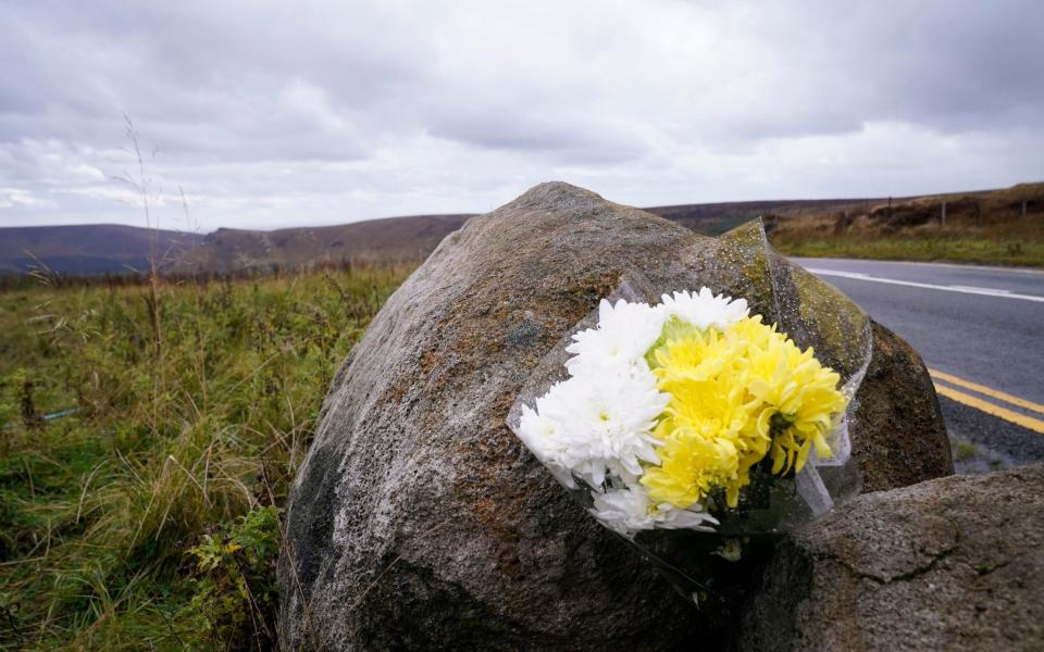 A floral tribute left on a rock on Saddleworth Moor - PA