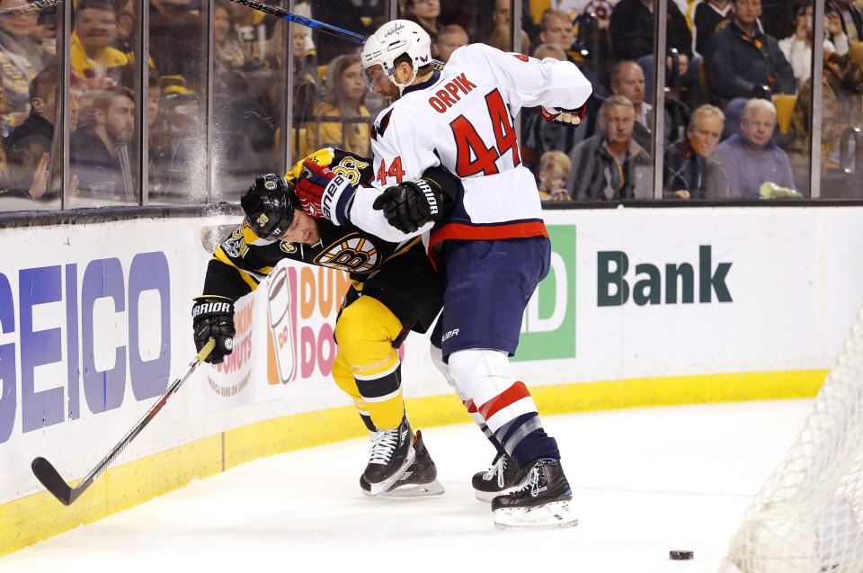 Washington Capitals' Brooks Orpik (44) holds Boston Bruins' Matt Beleskey away from the puck during the second period of an NHL hockey game in Boston, Saturday, April 8, 2017. (AP Photo/Winslow Townson)