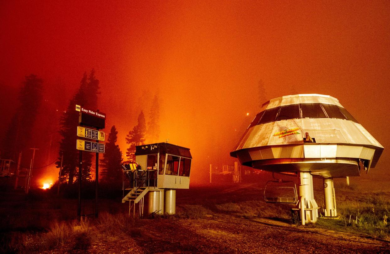 Flames surround a chair lift at Sierra-at-Tahoe Resort