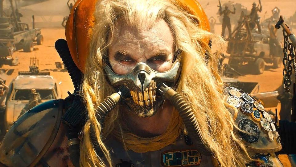 Immortan Joe in his mask standing before his War Boys in Mad Max: Fury Road