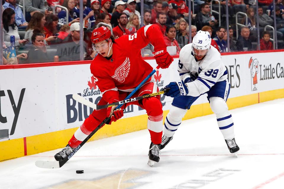 Detroit Red Wings defenseman Moritz Seider and Toronto Maple Leafs left wing Rich Clune battle for the puck in the third period at Little Caesars Arena, Sept. 27, 2019.