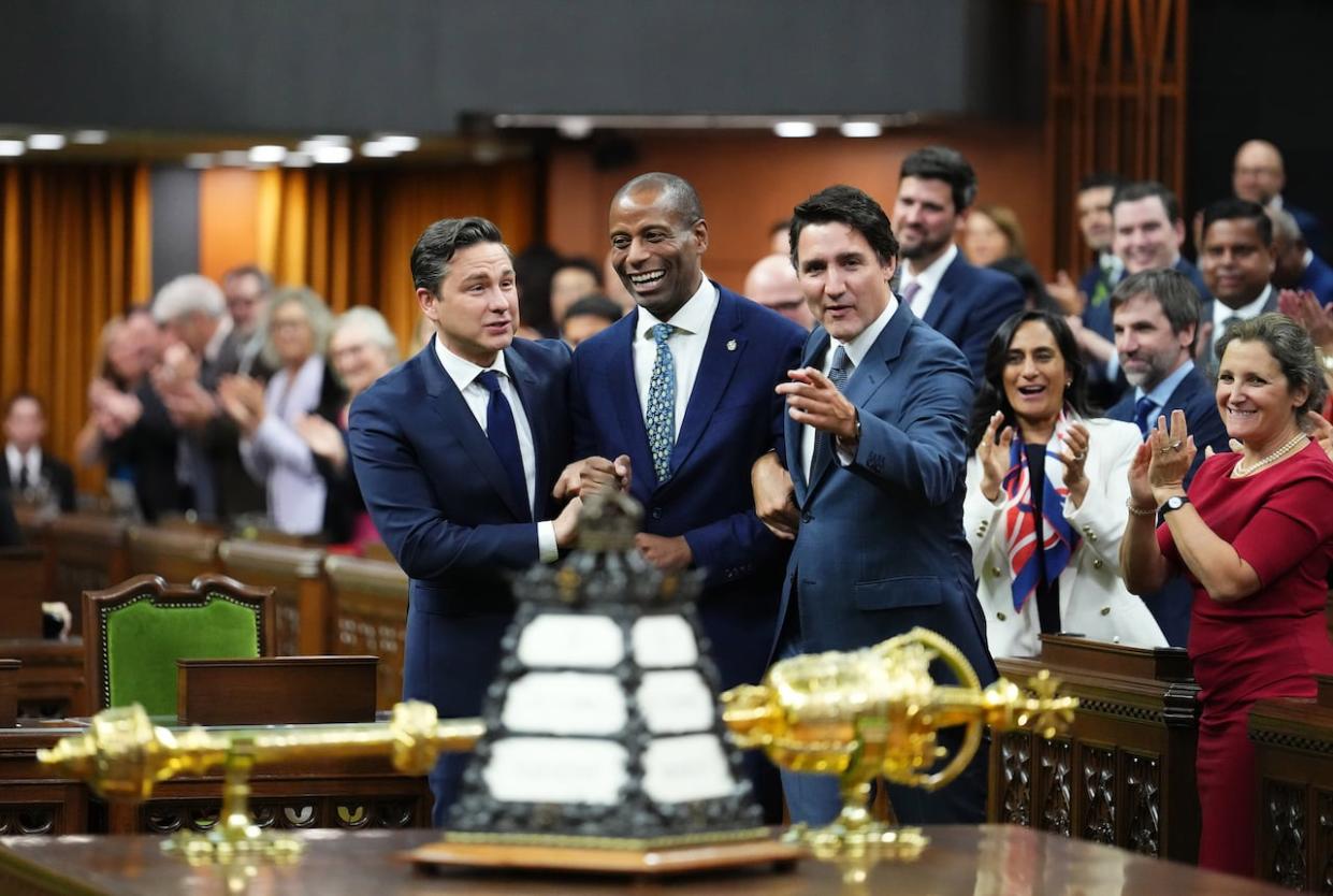 Newly elected Speaker of the House of Commons Greg Fergus is escorted into the House of Commons by Prime Minister Justin Trudeau and Conservative Leader Pierre Poilievre on Parliament Hill in Ottawa on Tuesday, Oct. 3, 2023. (Sean Kilpatrick/The Canadian Press - image credit)