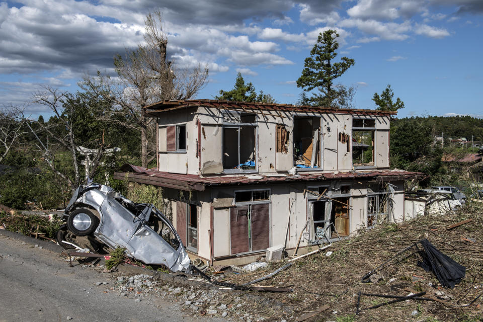 An upturned car lies next to a partially destroyed house after being hit by a tornado shortly before the arrival of Typhoon Hagibis, on Oct. 13, 2019, in Chiba, Japan. (Photo: Carl Court/Getty Images)