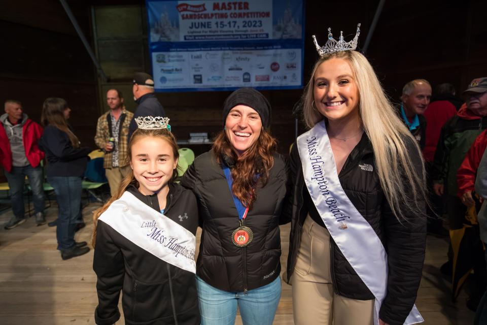 Mélineige Beauregard of Hawaii poses for a photo with Little Miss Hampton Beach Ella Kate Woods and Miss Hampton Beach Hannah Ritchie after being awarded 1st place for her sand sculpture "Love is a Universal Temple."